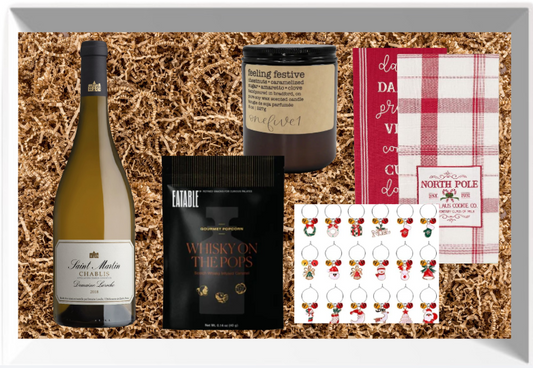 Gift box with wine, snacks and household decor